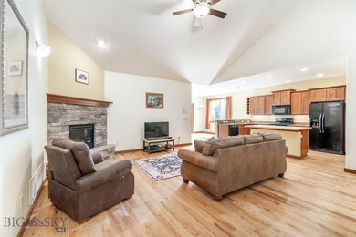 Living area with vaulted ceilings and gas fireplac