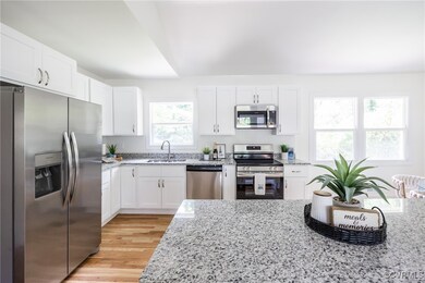 Kitchen with stainless steel appliances, a sink, l
