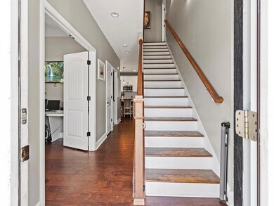 Stairway featuring wood finished floors and recess