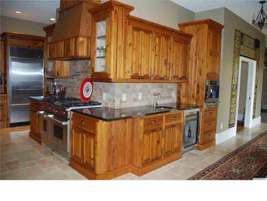 Custom cabinetry offers an abundance of storage for china and kitchenware, In addition there is a large walk in pantry that will accommodate small kitchen appliances and groceries.