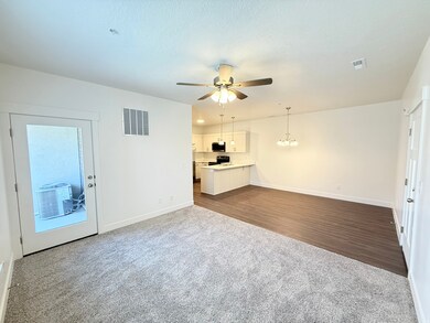 Living room featuring carpet and ceiling fan