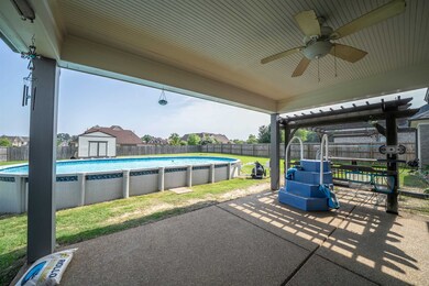 Fenced backyard featuring ceiling fan, a patio, and a shed