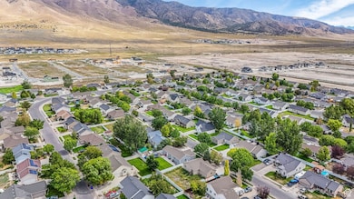 Aerial overview of property's location featuring nearby suburban area and mountains