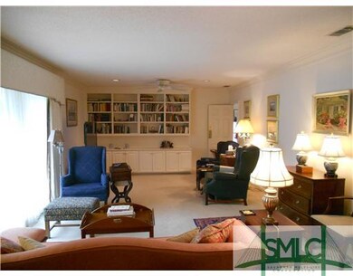Living Room. large windows opening onto covered pa
