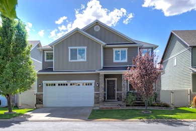 Craftsman house featuring stone siding, board and batten siding, a garage, concrete driveway, and a porch