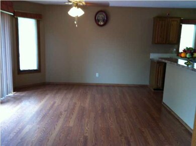 Dining area has beautiful wood laminate flooring f