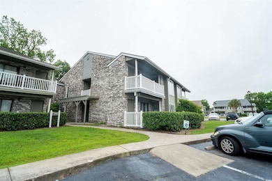 View of property featuring uncovered parking