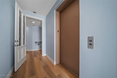 Hall featuring elevator and light hardwood / wood-