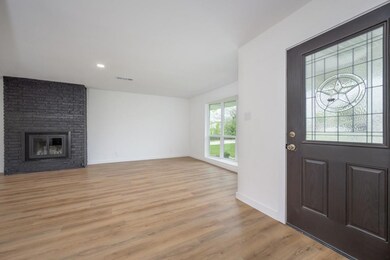 Foyer entrance with baseboards, visible vents, lig