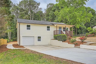Single story home with stairs, a garage, fence, an