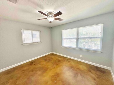 Empty room featuring baseboards, ceiling fan, and