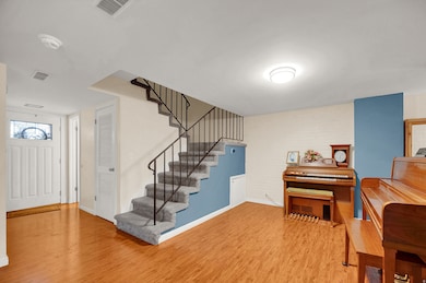 Foyer featuring light wood finished floors and stairs