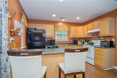 A townhome with 2 kitchen windows and a sliding do