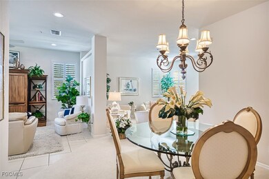 Dining space with light tile patterned flooring, recessed lighting, and a chandelier