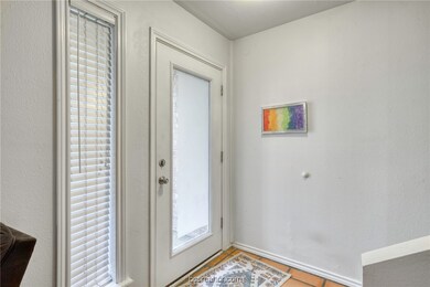 Doorway featuring light tile patterned flooring