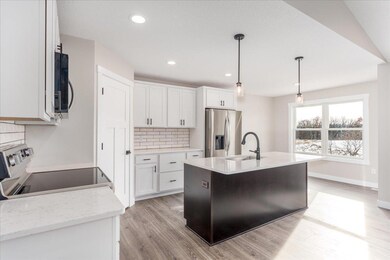 Spacious kitchen with Quartz countertops and tile backsplash.