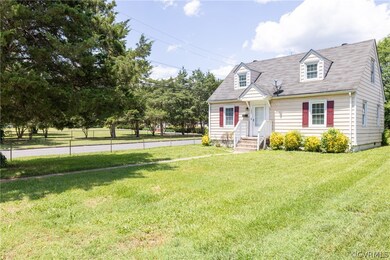 Cape cod-style house with a front yard