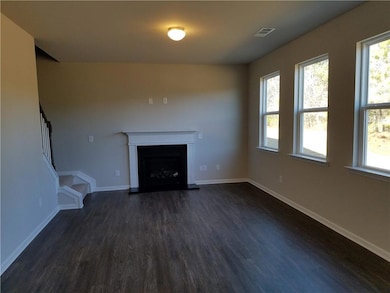 Unfurnished living room with visible vents, basebo