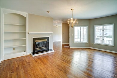Living room with hardwood floors, built ins & gas