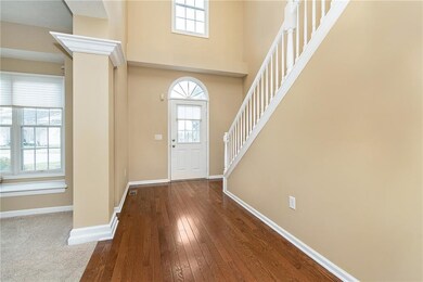 Beautiful 2 story entry way with wood flooring.
