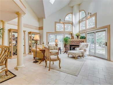 Great Room with wall of windows, brick fireplace a