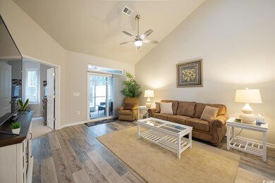 Living room featuring ceiling fan, high vaulted ce