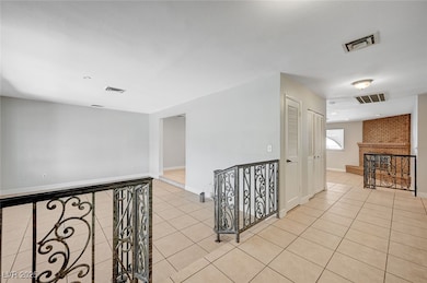 Hall featuring light tile patterned flooring and b