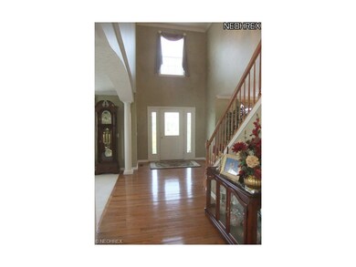 The hardwood floored 2 story foyer sets the tone f