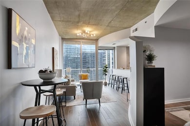 Dining room featuring expansive windows and dark wood-style flooring