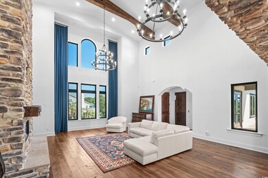 Living room with a towering ceiling, wood-type flo