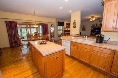 Kitchen with island and view to 3 season room.