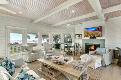 The living room offers a wood burning fireplace, s