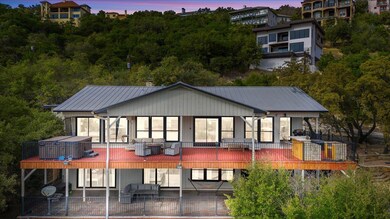 Back of property at dusk with a patio area, metal