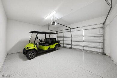Garage with baseboards and a garage door opener