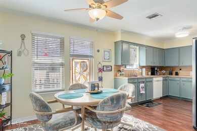 Kitchen with dark wood-type flooring, ceiling fan,