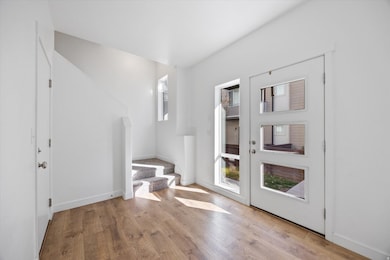 Foyer entrance featuring stairway and light wood finished floors