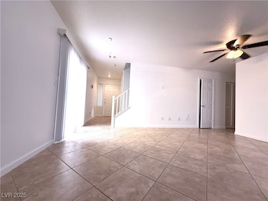 Empty room with stairway, tile patterned flooring,