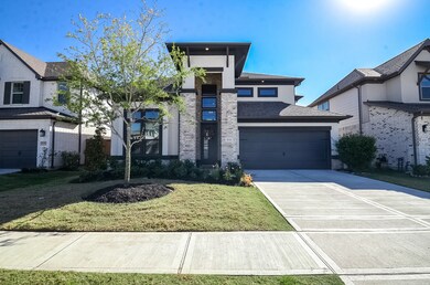 Modern two-story home with a sleek facade, featuring a two-car garage and a neatly landscaped front yard. The property exudes contemporary charm with its clean lines and large windows. Ideal for families seeking a stylish and functional living space.