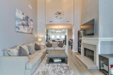 Stunning high ceilings in living room. Fireplace has granite to the length of the wall.