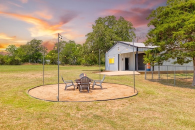 Yard at dusk featuring an outbuilding and an outd