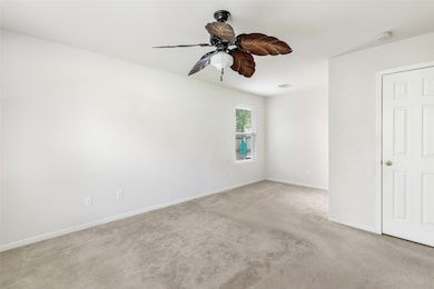 Spacious primary bedroom featuring a private en su