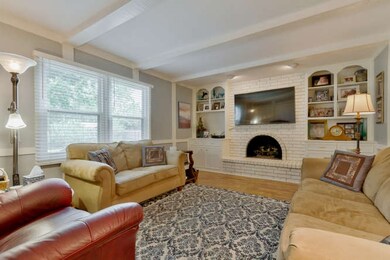 This family room has a beautiful fireplace and gre