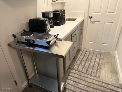 Office with wood finished floors and a textured wall