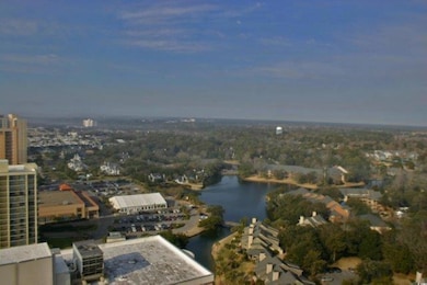 Aerial overview of property's location with a large body of water