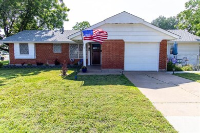 Ranch-style home with a garage and a front lawn