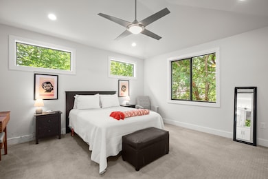 Bedroom with light carpet, recessed lighting, vau