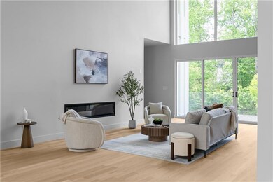 Living area with baseboards, light wood-style floo