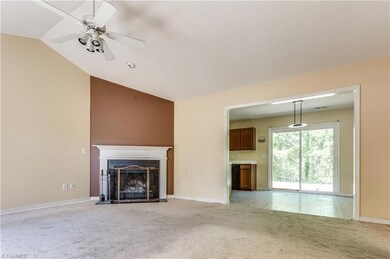 Vaulted ceilings, wood burning fireplace, eat in kitchen, and views into the private rear yard.