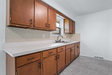The galley kitchen offers ample countertops perfect for meal prep. 