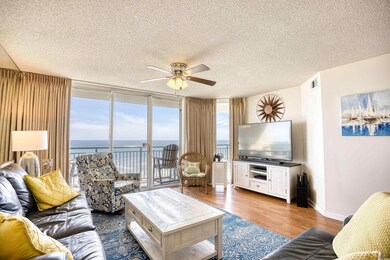 Living room with a textured ceiling, hardwood / wo